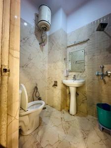 a bathroom with a toilet and a sink at HOTEL DEVA INN in Varanasi