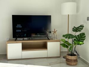 a flat screen tv sitting on a white entertainment center at Casa Virginia in Los Alcázares