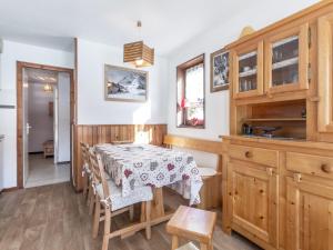a kitchen and dining room with a table and chairs at Appartement La Clusaz, 2 pièces, 4 personnes - FR-1-304-181 in La Clusaz
