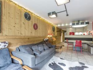 a living room with a couch and a table at Appartement Confortable au Coeur du Village, Proche des Pistes avec Terrasse et Garage - FR-1-304-191 in La Clusaz