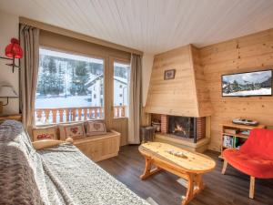 a living room with a couch and a fireplace at Appartement La Clusaz, 3 pièces, 6 personnes - FR-1-304-82 in La Clusaz
