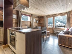 a kitchen and living room with a view of a mountain at Appartement 4★, 5 pers, ski au pied, proche centre - FR-1-304-149 in La Clusaz