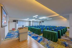 a room with tables and chairs and a podium at Hanting Hotel Xiamen Huli Avenue Free Trade Zone in Huli