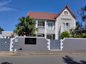 a white house with a gate and a fence at Luxe Florida Grand Hotel in Durban