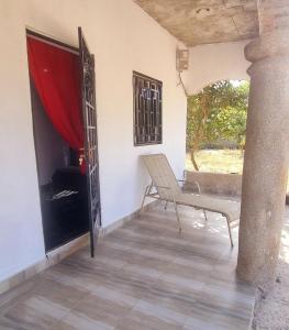 a room with a chair and a table and a window at KAIRO in Brufut