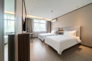 A bed or beds in a room at Hanting Hotel Shanghai Safari Park Nanzhu Road