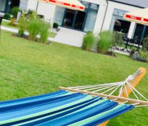 a hammock on the grass in front of a house at Hotel Mazovia Airport Modlin in Nowy Dwór Mazowiecki