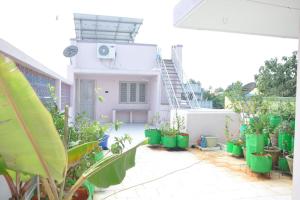 a patio with plants in front of a house at Roof-top stay in centre of city in Thanjāvūr