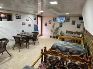 a room with a bed and a table and chairs at Hotel Ravshan Boutique in Bukhara