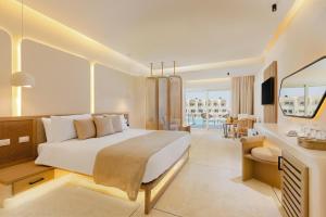 a bedroom with a large bed and a living room at Sunrise Anjum Resort in Marsa Alam City