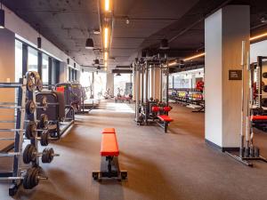 a gym with dumbbells and other equipment in a room at Sofitel Sydney Wentworth in Sydney