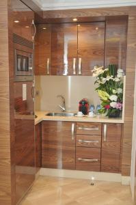 a kitchen with wooden cabinets and a sink at Suite Hotel Casa Diamond in Casablanca