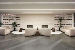 a lobby with white chairs and a fireplace at DoubleTree By Hilton Montreal in Montreal
