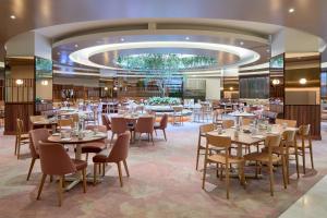 a restaurant with tables and chairs in a room at DoubleTree By Hilton Montreal in Montréal