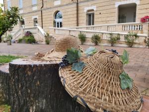 a basket on a tree stump in front of a building at Villa Contessina in Cossignano