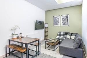 a living room with a couch and a table at Newly Renovated Upnor House with 2 Free Parking by Prescott Apartments in Bristol