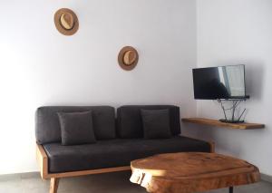 a living room with a couch and a coffee table at Κalamitsi Rooms & Apartments in Kimolos