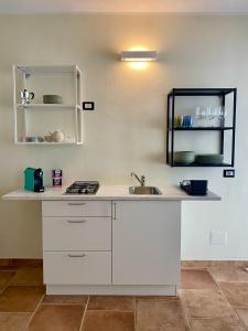a kitchen with a sink and a counter at Domu Su Neulaghe in Villasimius
