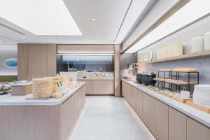 a kitchen with a bakery with a lot of food at Ji Hotel Shanghai Lujiazui World Plaza in Shanghai