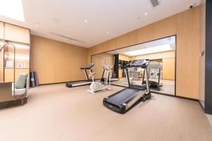 a gym with several exercise equipment in a room at Ji Hotel Zhenjiang Railway Station Nan Square in Zhenjiang
