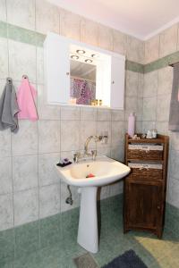 a bathroom with a sink and a mirror at Aoria Traditional House in Loúlos