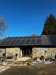 a house with solar panels on the roof at Yr Ysgubor Converted milking parlour in Llandysul