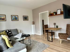 a living room with a couch and a table at Gästeapartement Markkleeberg in Markkleeberg