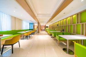 a dining room with green tables and chairs at Hanting Hotel Shanghai Jiading New Town Malu in Jiading