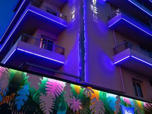 a building with purple lights on the side of it at ibis budget Menton Bord de Mer in Menton
