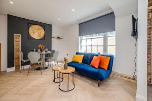 een woonkamer met een blauwe bank en een tafel bij 2 Bedroom 2Bathroom I Next To Brighton Beach I Sleep 6 in Brighton & Hove