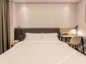 Postel nebo postele na pokoji v ubytování Hanting Premium Hotel Putian Wanda Plaza