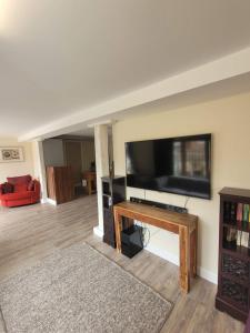a living room with a large flat screen tv at Milton Court in Sittingbourne
