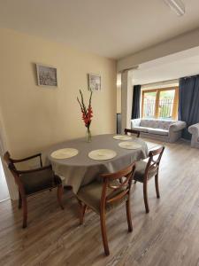 a dining room with a table and chairs and a couch at Milton Court in Sittingbourne