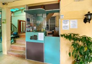 a kiosk in front of a building with stairs at RedDoorz Hostel @ Bunakidz Lodge El Nido Palawan in Santa Monica