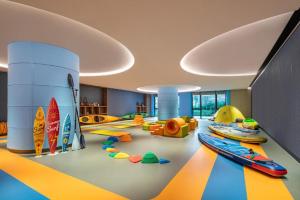 a childrens play room with surfboards on the floor at Song Hotel Jinan Fengming in Hongjialou