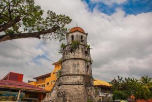a tall brick tower with a dome on top of it at Asia Novo Boutique Hotel-Dumaguete in Dumaguete