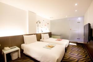 Postel nebo postele na pokoji v ubytování Moshamanla Hotel - Ximen
