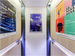 a hallway with two framed pictures on the walls at Lavande Hotel Beijing Shunyi Shimen Metro Station in Shunyi