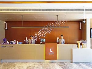 three men standing at a counter in an office at Lavande Hotel Shanghai Jing'an Shibei Gaoxin in Shanghai