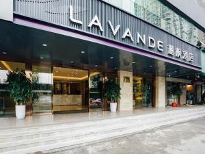 a store front of a building with potted plants at Lavande Hotel Wuhan Jianghan Road Jiqing Street in Wuhan