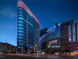 a tall building in a city at night at Lavande Hotel Zunyi Times Tianjie in Zunyi