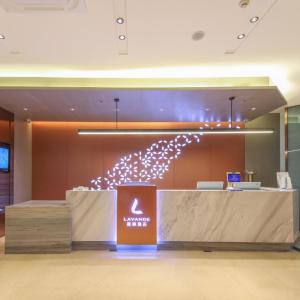 a lobby with a reception desk in a building at Lavande Hotel Wuhan Jianghan Road Dunli Gate Metro Station in Wuhan