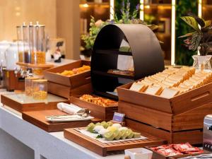 a buffet of food on a counter in a restaurant at Lavande Hotel Zhongshan Lihe Square in Zhongshan