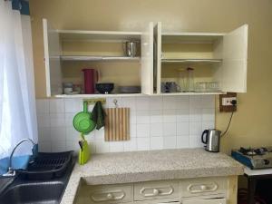 a kitchen with a sink and a counter top at Tudor Court in Mombasa