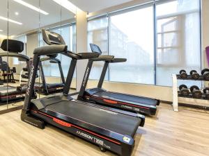 a gym with three exercise bikes in a room at Lavande Hotel Nanchong Xihua Shida in Nanchong