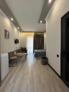 a living room with a couch and a table at Amroc Hotel - Հյուրանոց Ամրոց in Noyemberyan