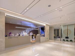 a lobby with a bar in a building at Lavande Hotel Wuhan 2nd Guanggu Road in Liufangling