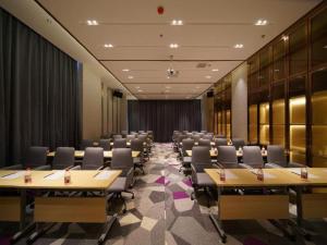 a conference room with rows of tables and chairs at Lavande Hotel Anshan City Center in Anshan
