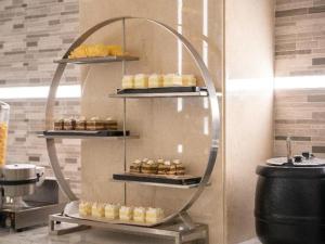 a display of pastries on a shelf in a kitchen at Lavande Hotel Anshan City Center in Anshan