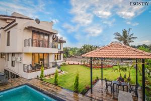 a villa with a swimming pool and a house at EKOSTAY- GOLD - Titanium Villa in Lonavala
